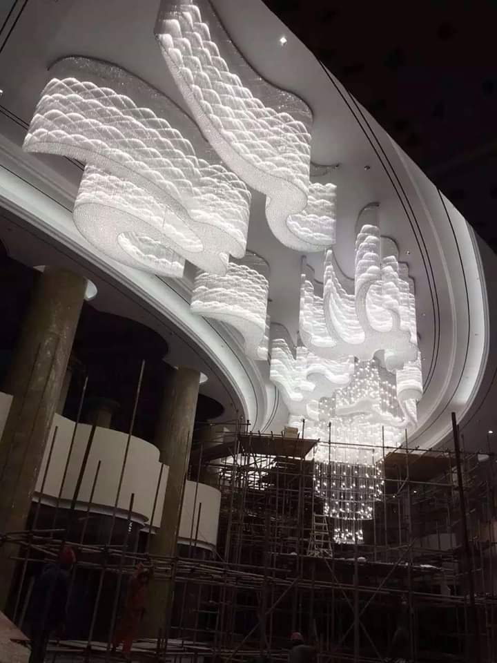 Large wave-like banquet chandelier installation at Luxe Cascade Pune