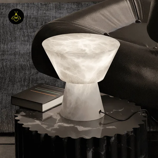 Alabaster mushroom table lamp glowing on a black side table beside a leather sofa