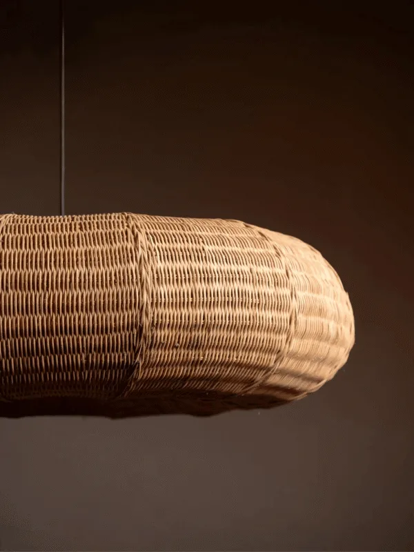 Close side view of the cane frame pendant light showing the tight handwoven rattan and cane weave