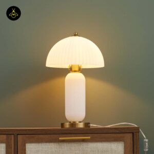 Vintage table lamp with adjustable amber glass shade on a plain background