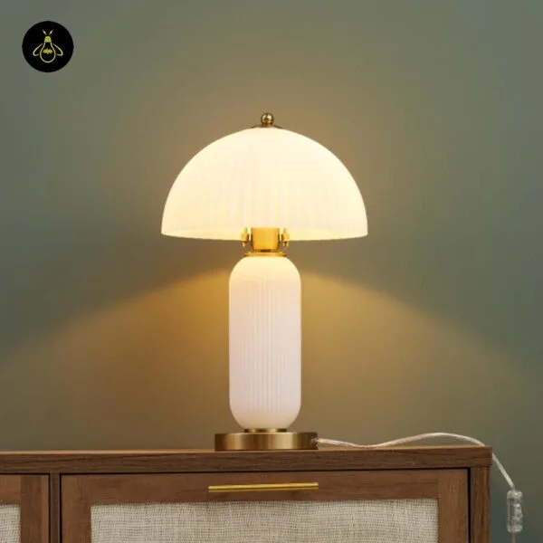 Fluted glass mushroom table lamp in opal borosilicate glass on a sideboard