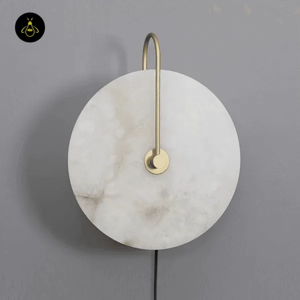 Gold plug in wall lamp switched off, showing the grey veins of the natural alabaster disc