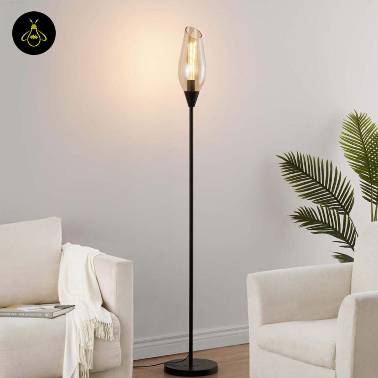 Front view of black floor lamp with a single amber glass teardrop shade
