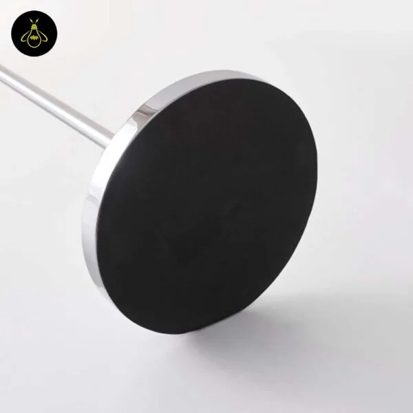 Round chrome base detail of amber glass floor lamp