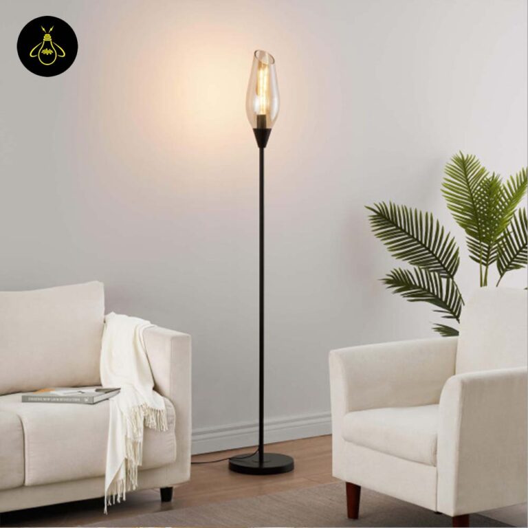 Black amber glass floor lamp casting warm ambient light in a modern interior