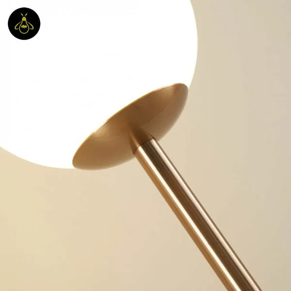 Brass dual globe floor lamp giving soft ambient light