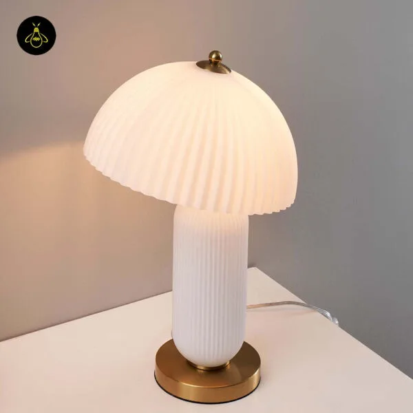 White fluted glass mushroom lamp casting warm ambient light