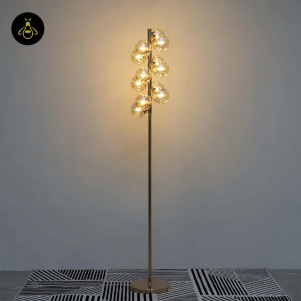 Front view of gold floor lamp with amber borosilicate glass sphere cluster