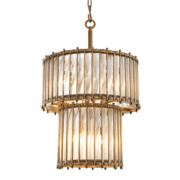 Antique brass chandelier seen from the front, warm light glowing through its twisted glass rods