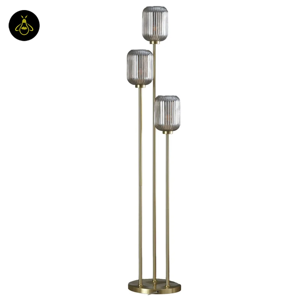 Triple Amber Glass Floor Lamp – 3-Light Gold Ribbed Glass Statement 6 Triple amber glass floor lamp creating warm ambient light in a bedroom