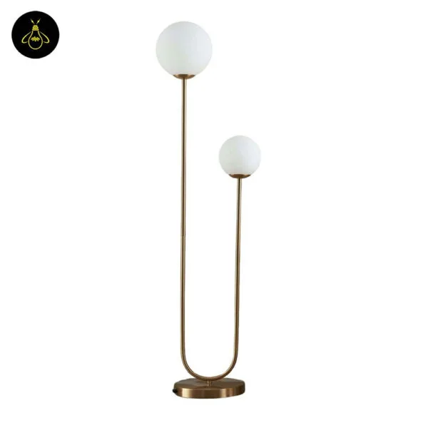 Brass dual globe floor lamp in a bedroom corner