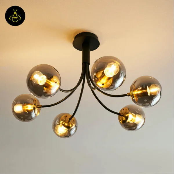Modern black glass ball chandelier giving warm ambient light in a stylish bedroom