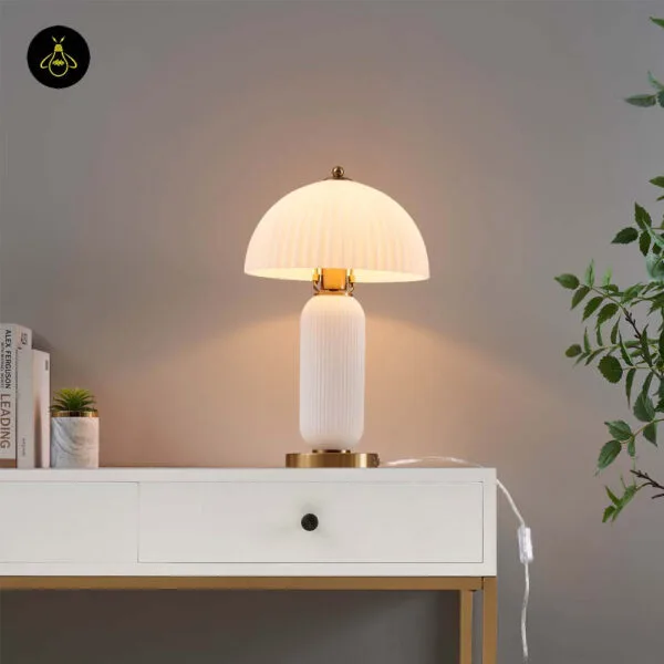 Fluted glass mushroom table lamp on a bedroom console with warm glow