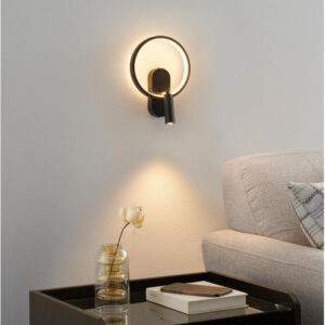 Black circle wall light with centred reading light in a living room