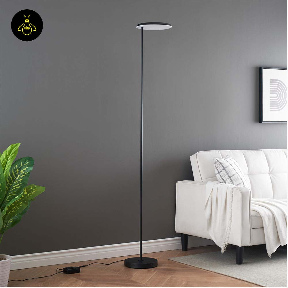 Black LED floor lamp with adjustable head creating warm indirect ambient light beside a sofa