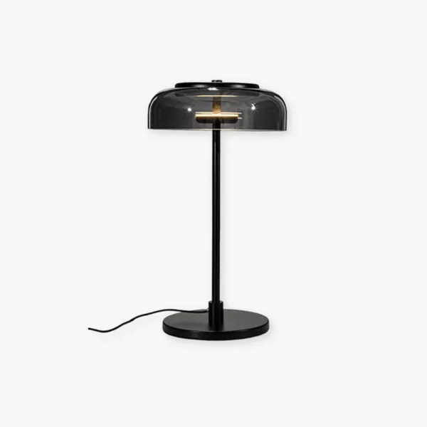 Black table lamp with a smoked borosilicate glass dome lit warm over a slim stainless steel stem and round base