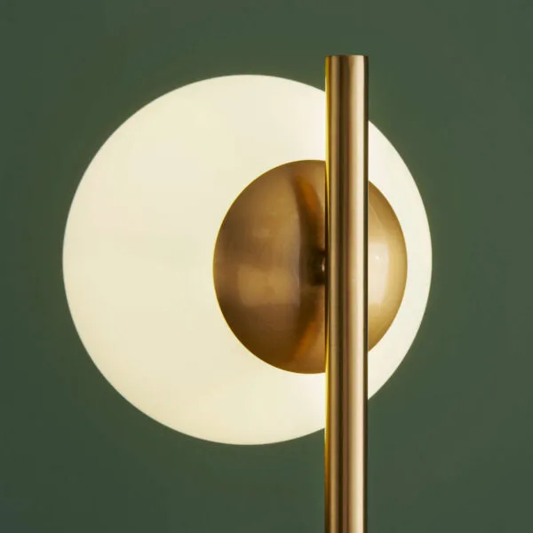 Marble table lamp with opal borosilicate glass globe on a bedroom nightstand
