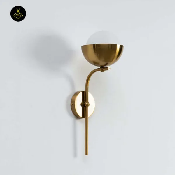 Opal white light unlit, side view of the globe wall lamp on a white wall showing the curved stem and round backplate