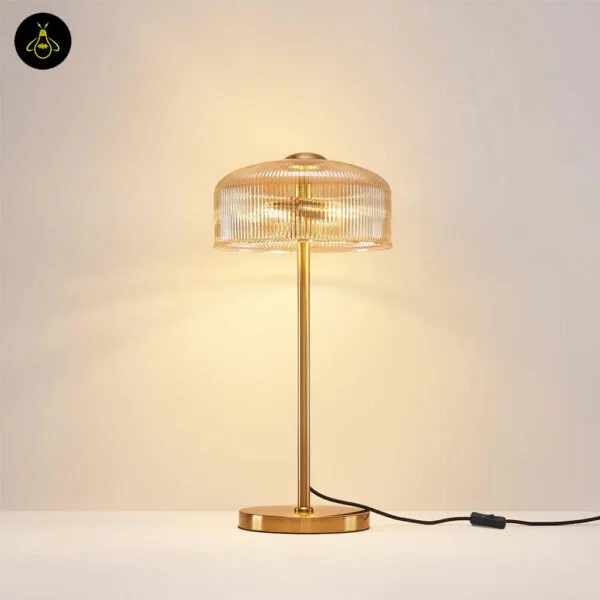 Brass-finish stem detail of the ribbed amber glass table lamp