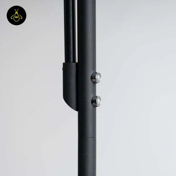 Black LED floor lamp with reading light styled beside indoor plants