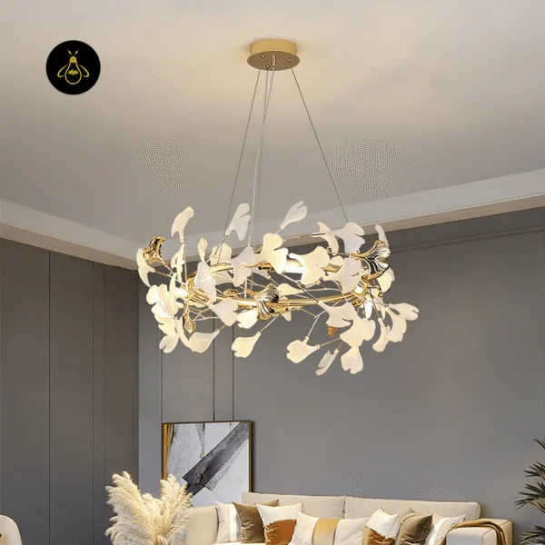 White ceramic ginkgo leaves on the gold branches of a JagMag leaf chandelier
