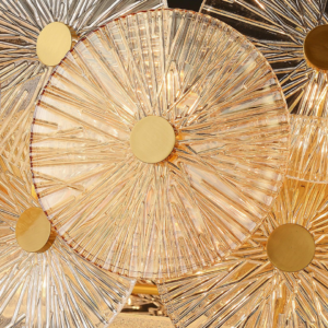 Gold fluted glass chandelier with amber discs over a dining room table
