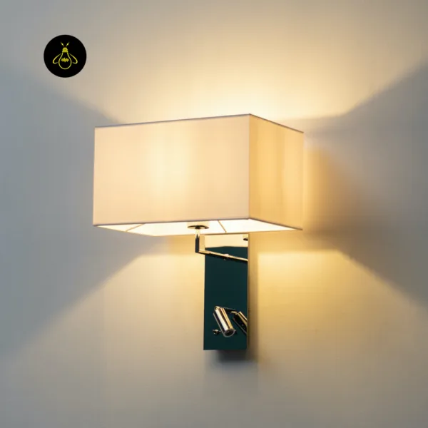 Side view of the lit wall mounted bedside light throwing warm light up and down the wall