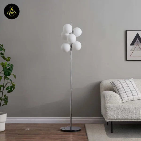 Chrome glass-sphere floor lamp in a bedroom setting