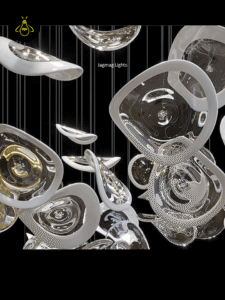 Close-up of hand-blown clear and frosted glass leaves with gold accents on a modern glass jhumar