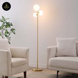 Gold glass globe floor lamp with three white opal spheres in a contemporary living room