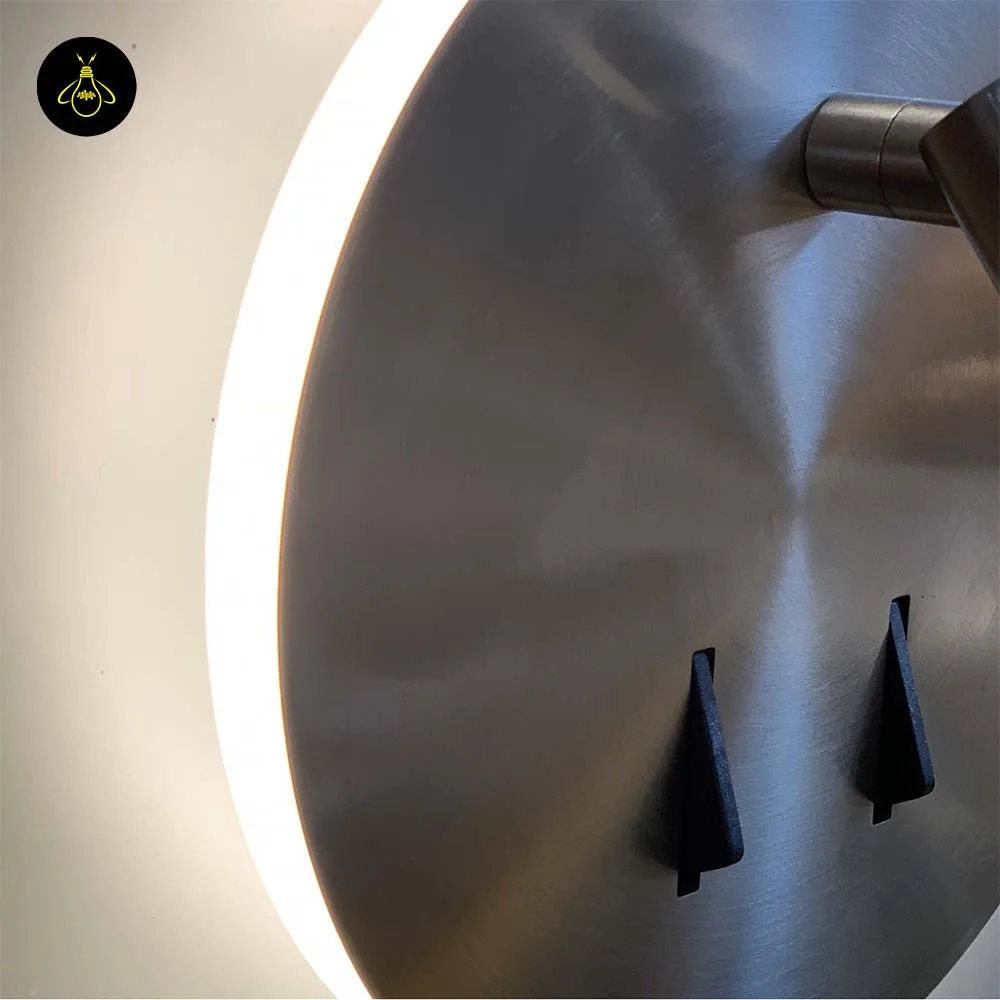 Wall Mounted Reading Light – LED Double Light, Chrome Finish 3 Close-up of the wall lamp for bedroom: brushed steel disc edge with backlit halo and two black toggle switches