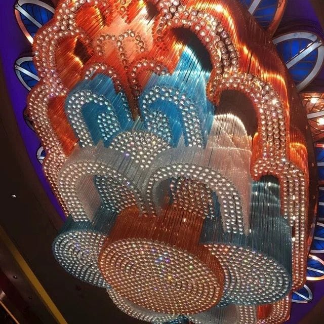 How to Choose the Perfect Banquet Hall Chandelier or Hotel Lobby Fixture 2 Banquet hall chandelier: a custom crystal chandelier in layered orange, blue and clear strands lit on a hall ceiling