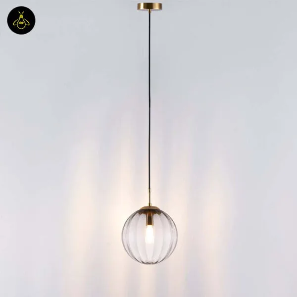 Full drop of the ribbed glass ball pendant light: round gold canopy, long black cable and a 20 cm ribbed globe
