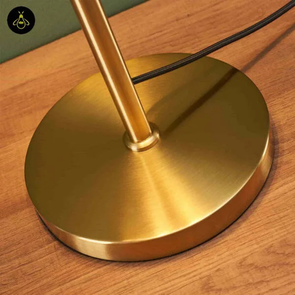 Amber glass table lamp with a luxury brass-finish on a desk