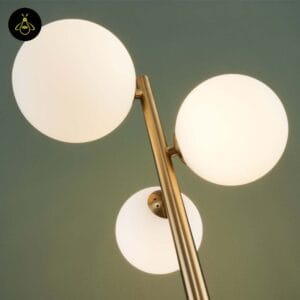 White opal globes glowing warm on the gold glass globe floor lamp