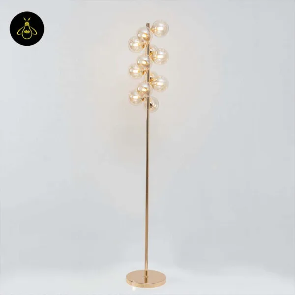 Gold floor lamp with amber borosilicate glass spheres in a lobby-style setting