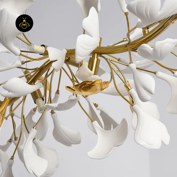 Close-up of gold branches, white ceramic gingko petals and G9 LED bulbs on the chandelier