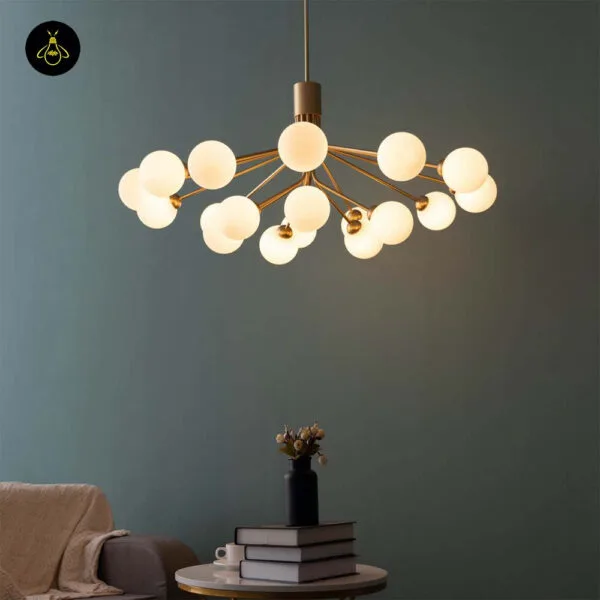 Brass-finish modern chandelier with opal borosilicate glass globes hanging in a living room