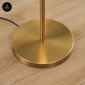Close-up of the round 25 cm gold base of the glass globe floor lamp