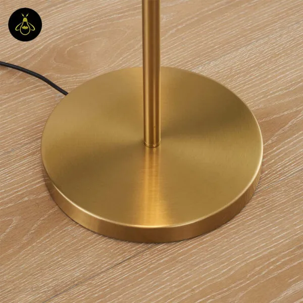 Close-up of the round 25 cm gold base of the glass globe floor lamp