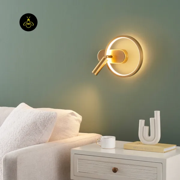 Gold circle wall light beside a sofa and white side table in a living room