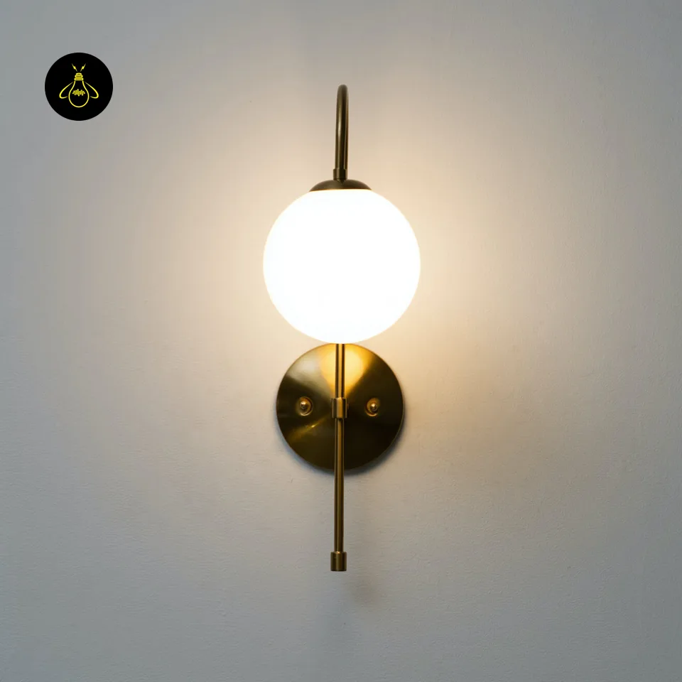 Oriol Frosted Glass Globe Wall Sconce – 48 cm Antique Gold Arch | Jagmag Lights 6 Slim vintage-gold metal arm of the gold living room wall light holding a opal borosilicate glass globe