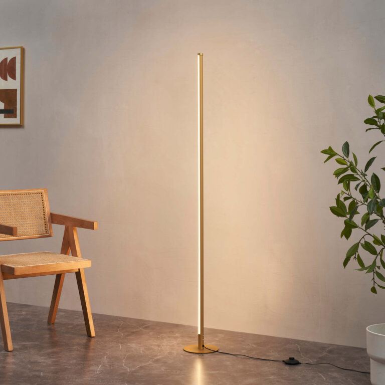 Slim gold LED floor lamp with illuminated stem and round disc base