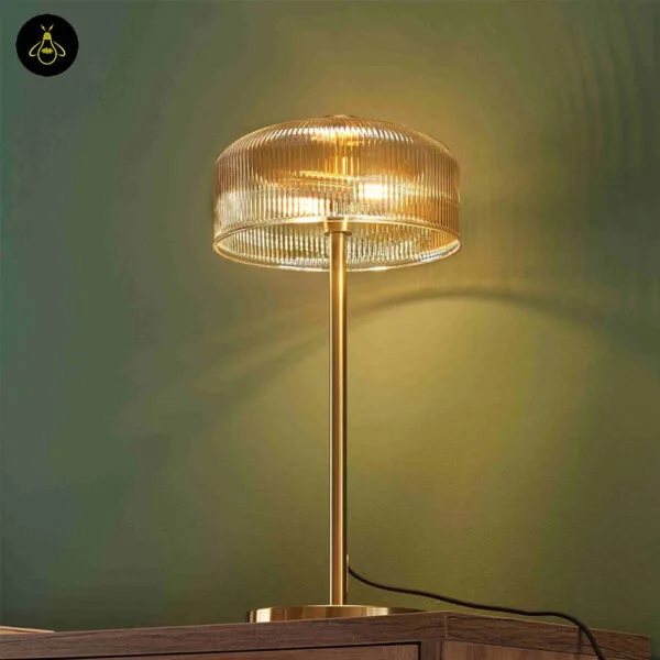 Ribbed amber glass table lamp on a hotel desk