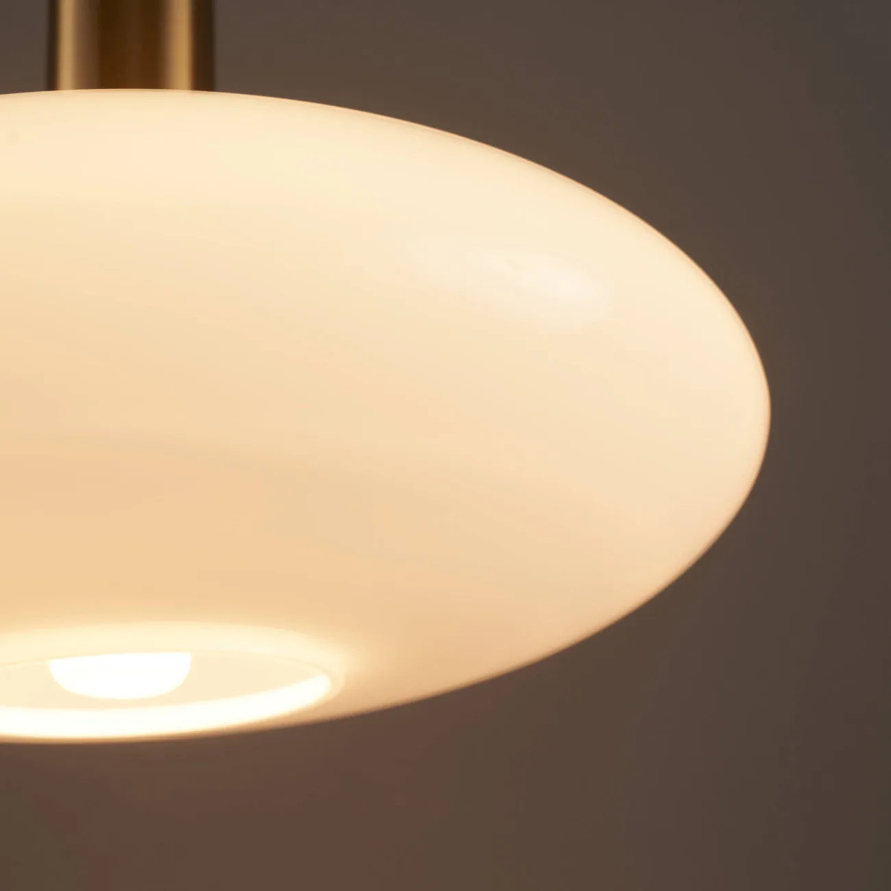 Opaline Glass Pendant Light – Round Brass-Finish Design 5 Opaline glass pendant light installed in a hotel lobby interior
