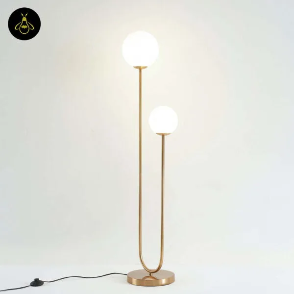 Brass dual globe floor lamp in a hotel suite