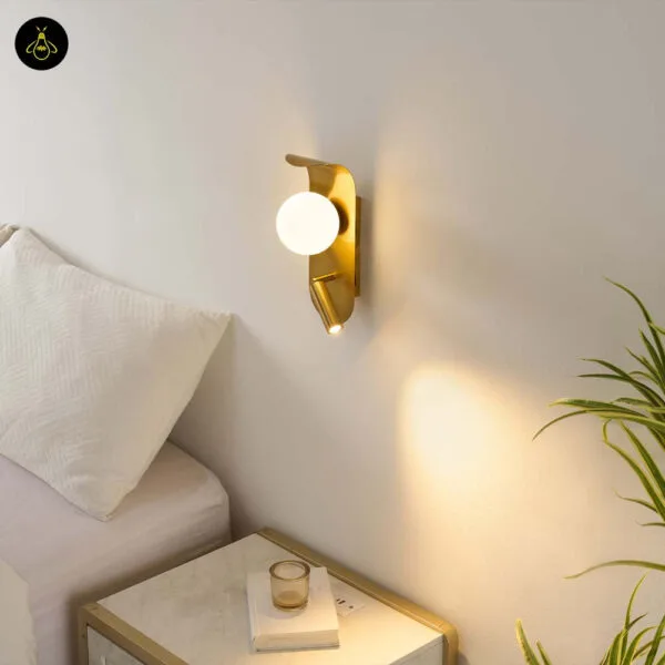 Bedroom reading light beside a bed, reading spot aimed down at the bedside table and opal borosilicate glass globe lit