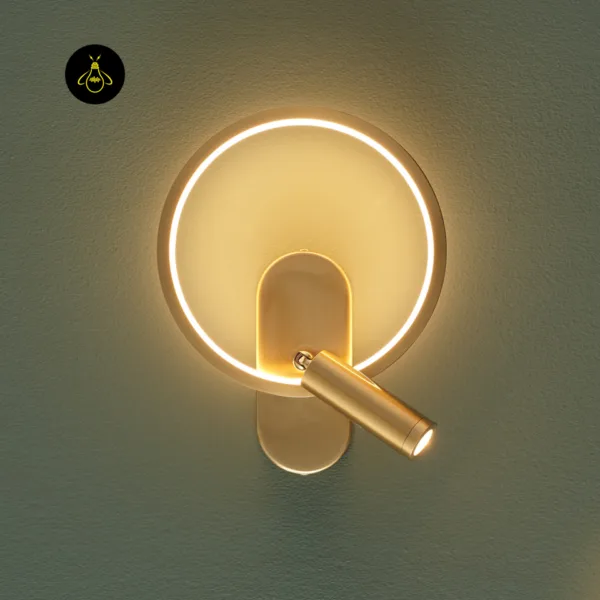 Gold circle wall light with the reading spot angled down to the right