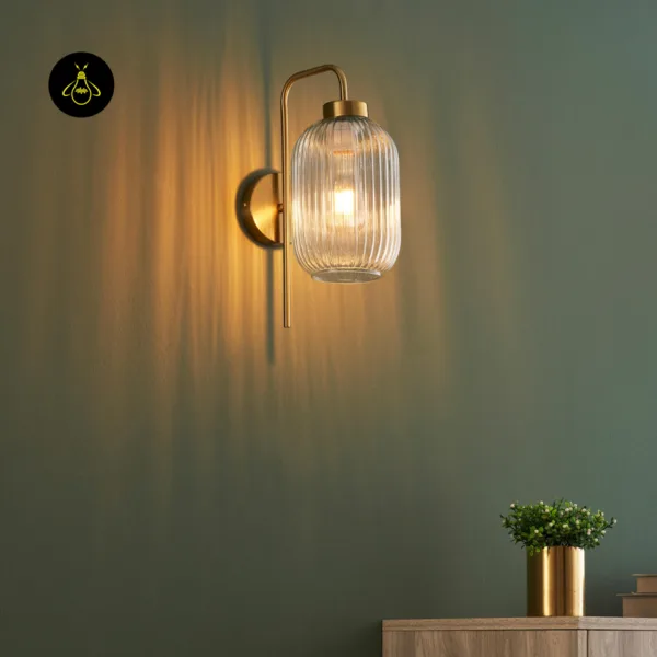 Fluted glass wall light throwing vertical lines of warm light up a green wall