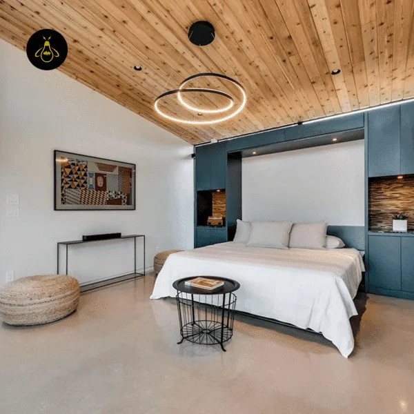Spiral ring chandelier installed over a bedside in a modern bedroom